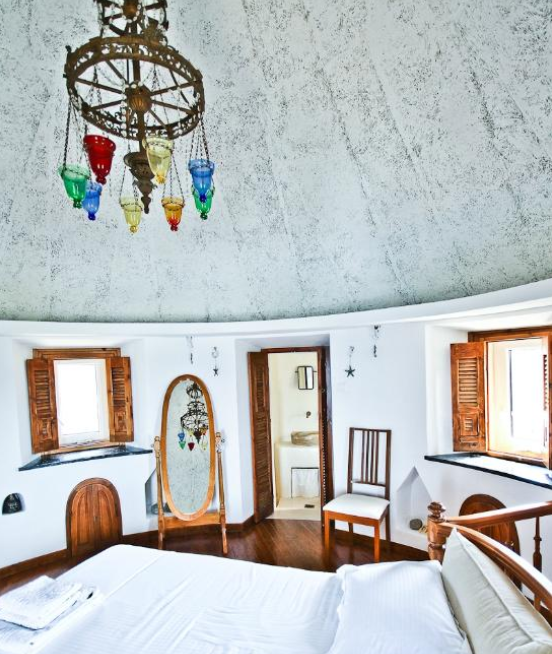 Castle Panigirakis. Windmill's roof, main bedroom with sunset sea view