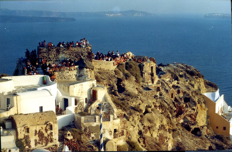 Crowds in Oia village of Santorini, waiting to see the famous sunset of Oia, one of the best in the world.